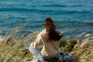 woman meditation at the seaside rock cliff edge